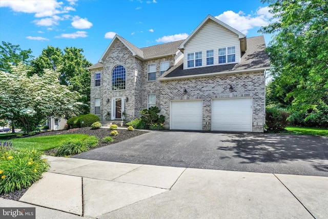 1215 Oakwood Ln, York, PA 17403 - view of front of home featuring driveway, an attached garage, and brick siding