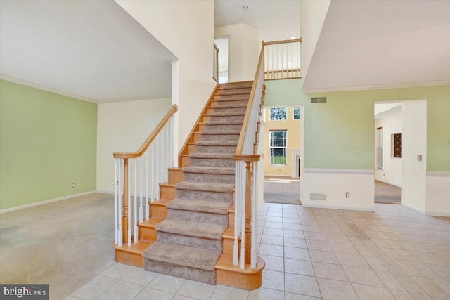 1215 Oakwood Ln, York, PA 17403 - stairway with crown molding, a high ceiling, baseboards, and tile patterned floors