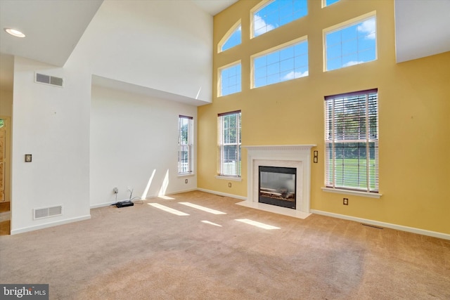1215 Oakwood Ln, York, PA 17403 - unfurnished living room featuring carpet flooring, baseboards, plenty of natural light, a high ceiling, and a premium fireplace