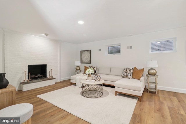 3233 Ellicott St NW, Washington, DC 20008 - living area featuring light wood-style floors, baseboards, a brick fireplace, recessed lighting, and ornamental molding