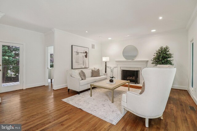 3233 Ellicott St NW, Washington, DC 20008 - living area with wood finished floors, a fireplace, crown molding, baseboards, and recessed lighting