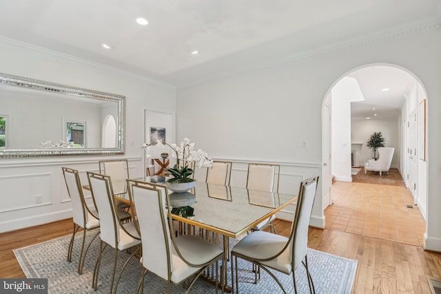 3233 Ellicott St NW, Washington, DC 20008 - dining space with arched walkways, light wood-style flooring, ornamental molding, and recessed lighting