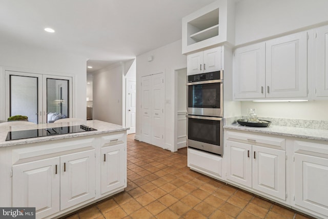 3233 Ellicott St NW, Washington, DC 20008 - kitchen with stainless steel double oven, black electric cooktop, white cabinetry, recessed lighting, and light stone counters