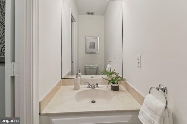 3233 Ellicott St NW, Washington, DC 20008 - bathroom with vanity, toilet, and baseboards
