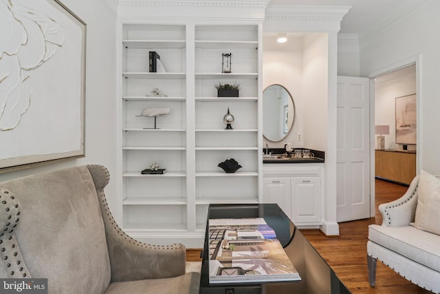 3233 Ellicott St NW, Washington, DC 20008 - sitting room featuring wood finished floors, built in shelves, and ornamental molding