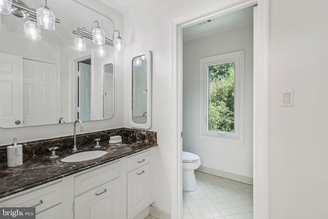 3233 Ellicott St NW, Washington, DC 20008 - bathroom featuring vanity, toilet, and baseboards