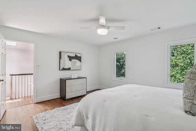 3233 Ellicott St NW, Washington, DC 20008 - bedroom with wood finished floors, multiple windows, and baseboards