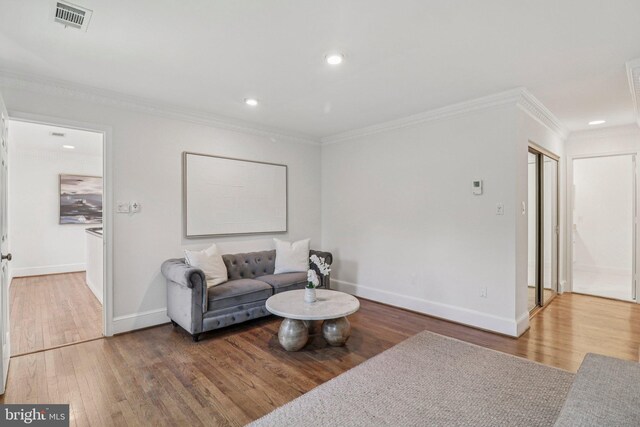3233 Ellicott St NW, Washington, DC 20008 - living room with wood finished floors, baseboards, crown molding, and recessed lighting