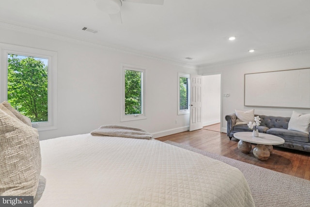 3233 Ellicott St NW, Washington, DC 20008 - bedroom with multiple windows, wood finished floors, ornamental molding, baseboards, and recessed lighting