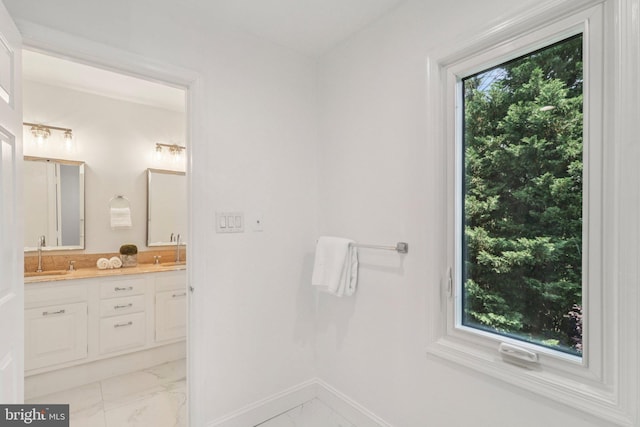 3233 Ellicott St NW, Washington, DC 20008 - bathroom with marble finish floors, double vanity, and baseboards