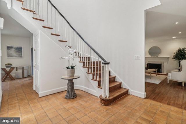 3233 Ellicott St NW, Washington, DC 20008 - staircase featuring recessed lighting, a fireplace, and baseboards