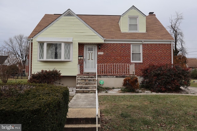 3316 Fairview Rd, Baltimore, MD 21207 - view of front of home with brick siding, a chimney, a front yard, and roof with shingles