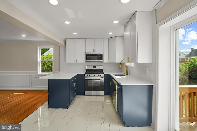 3316 Fairview Rd, Baltimore, MD 21207 - kitchen with stainless steel appliances, blue cabinetry, a sink, a peninsula, and recessed lighting