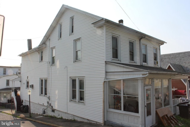 24 S 7th St, Shamokin, PA 17872 - view of property exterior featuring a sunroom and a chimney