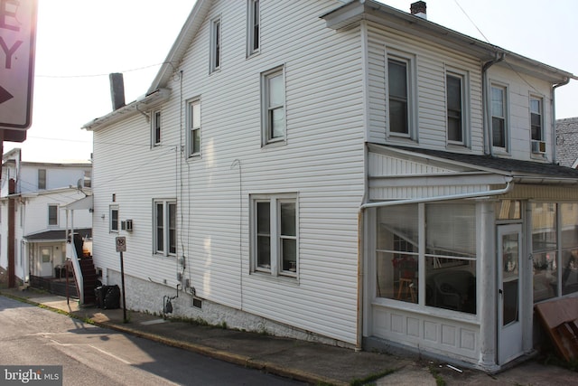 24 S 7th St, Shamokin, PA 17872 - view of property exterior with a sunroom and a chimney