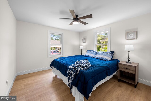5600 Patrick Henry, Baltimore, MD 21225 - bedroom with multiple windows, light wood finished floors, baseboards, and a ceiling fan