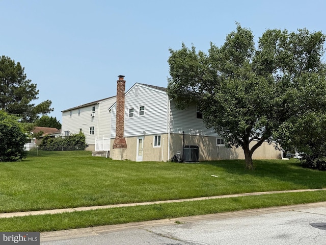 2 Renai Ct, Newark, DE 19702 - view of side of home featuring central AC, a lawn, and a chimney
