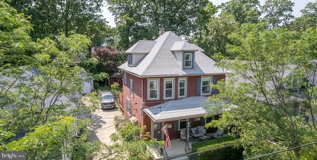 218 New Jersey Ave, Collingswood, NJ 08108 - view of front of home with a chimney, roof with shingles, view of wooded area, and an outdoor structure