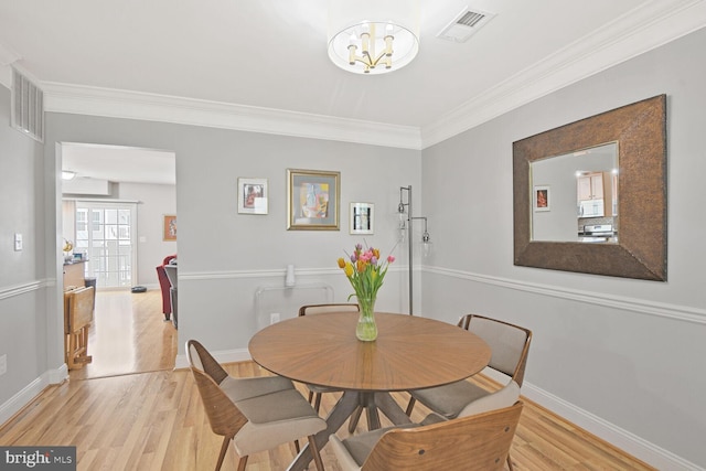 22946 Spicebush Dr Unit 1382, Clarksburg, MD 20871 - dining room featuring ornamental molding, light wood finished floors, baseboards, and a chandelier