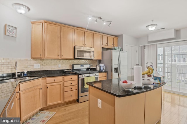 22946 Spicebush Dr Unit 1382, Clarksburg, MD 20871 - kitchen with appliances with stainless steel finishes, a sink, light wood-type flooring, and tasteful backsplash