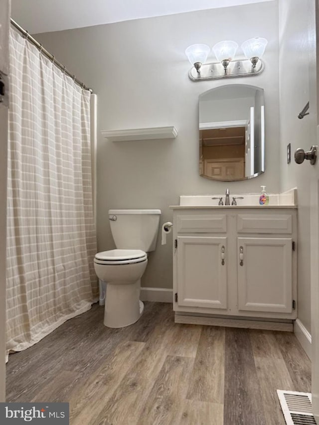 39410 Thomas Dr, Mechanicsville, MD 20659 - full bathroom featuring toilet, vanity, wood finished floors, and baseboards