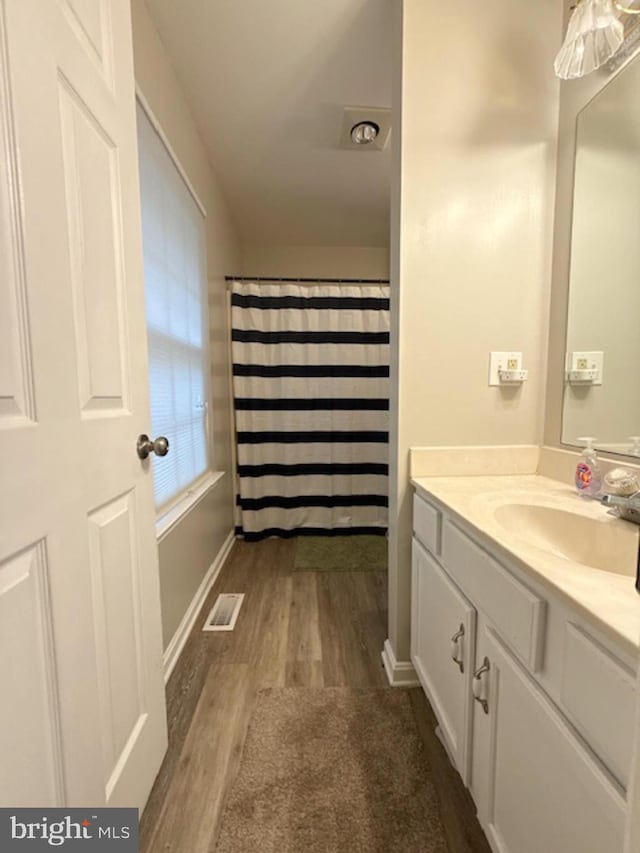 39410 Thomas Dr, Mechanicsville, MD 20659 - full bathroom with wood finished floors, vanity, baseboards, and a shower with shower curtain