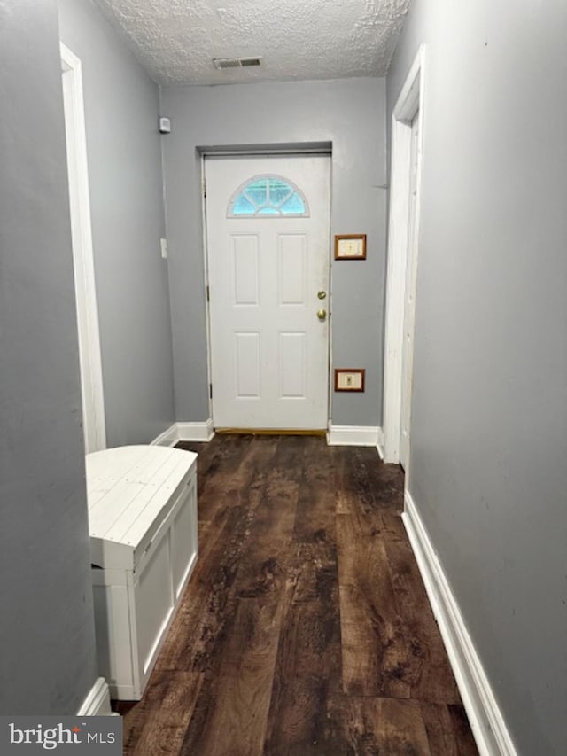 39410 Thomas Dr, Mechanicsville, MD 20659 - entryway featuring dark wood-type flooring, a textured ceiling, and baseboards