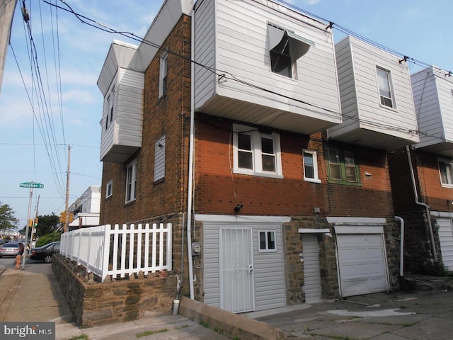 6001 N Mascher St, Philadelphia, PA 19120 - view of front of house featuring brick siding and an attached garage