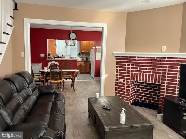 6001 N Mascher St, Philadelphia, PA 19120 - living room with light wood-type flooring, a brick fireplace, and stairway
