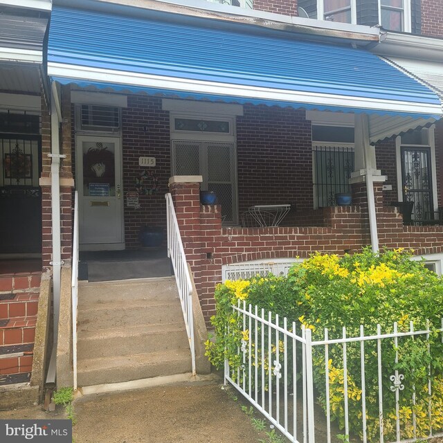 1115 Bentalou St, Baltimore, MD 21216 - property entrance featuring brick siding and covered porch