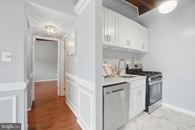 4379 Americana Dr Unit 201, Annandale, VA 22003 - kitchen featuring appliances with stainless steel finishes, a sink, white cabinetry, and light countertops