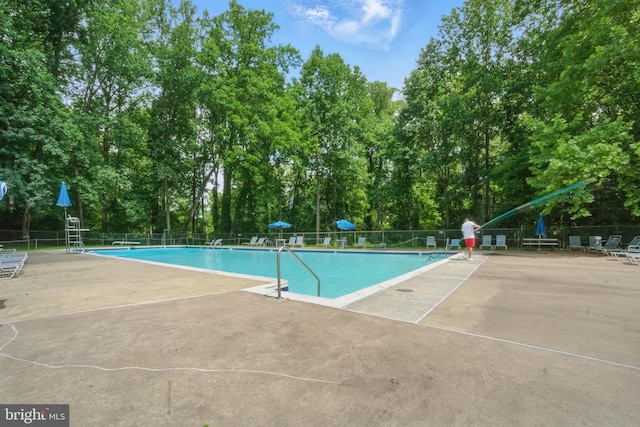 4379 Americana Dr Unit 201, Annandale, VA 22003 - community pool featuring a patio area and view of wooded area