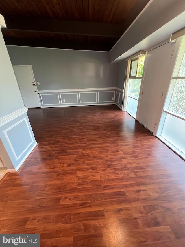 4379 Americana Dr Unit 201, Annandale, VA 22003 - spare room featuring dark wood-style floors, wood ceiling with exposed beams, wainscoting, and a decorative wall