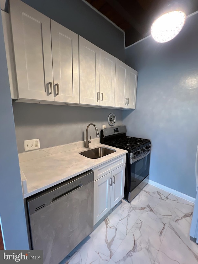 4379 Americana Dr Unit 201, Annandale, VA 22003 - kitchen with stainless steel appliances, a sink, light countertops, light marble finish flooring, and white cabinetry