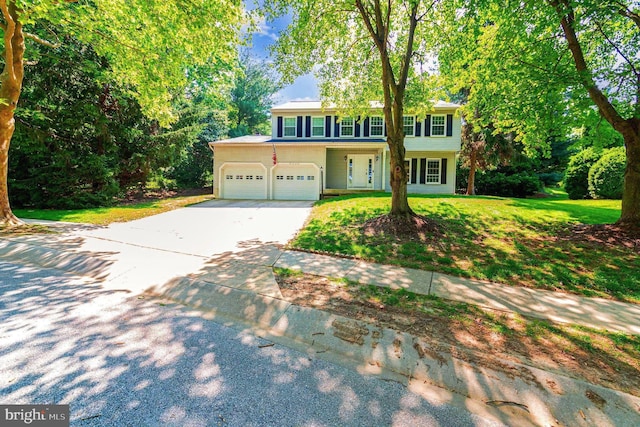 8608 Goldenstraw Ln, Columbia, MD 21045 - view of front of home with concrete driveway, an attached garage, and a front yard