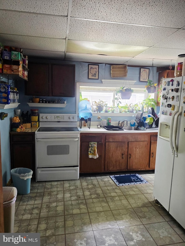 268 Market St, Carneys Point, NJ 08069 - kitchen featuring white appliances, a drop ceiling, a sink, light countertops, and brown cabinetry