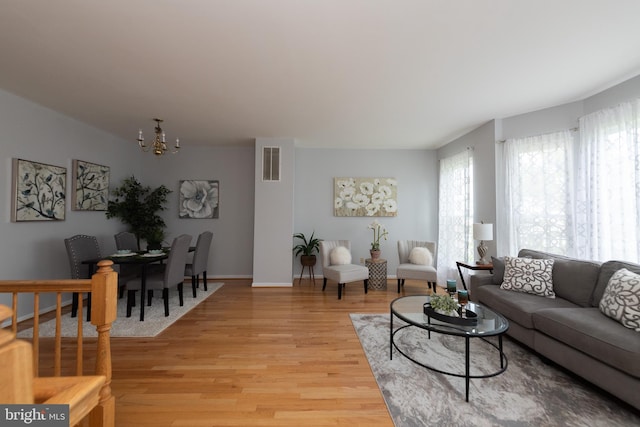 20976 Kittanning Ln, Ashburn, VA 20147 - living room with a chandelier, light wood-style flooring, and baseboards