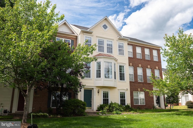 20976 Kittanning Ln, Ashburn, VA 20147 - townhome / multi-family property with a front lawn and brick siding
