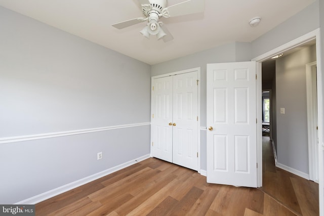 20976 Kittanning Ln, Ashburn, VA 20147 - unfurnished bedroom with wood finished floors, baseboards, a closet, and a ceiling fan