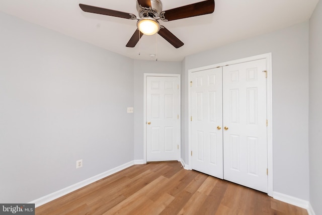 20976 Kittanning Ln, Ashburn, VA 20147 - unfurnished bedroom with light wood-style flooring, baseboards, a closet, and a ceiling fan