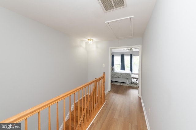20976 Kittanning Ln, Ashburn, VA 20147 - hallway featuring attic access, wood finished floors, and an upstairs landing