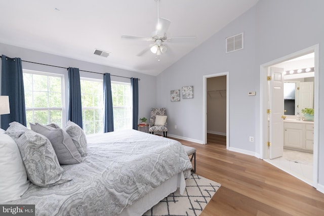 20976 Kittanning Ln, Ashburn, VA 20147 - bedroom featuring light wood finished floors, a spacious closet, baseboards, high vaulted ceiling, and ensuite bathroom