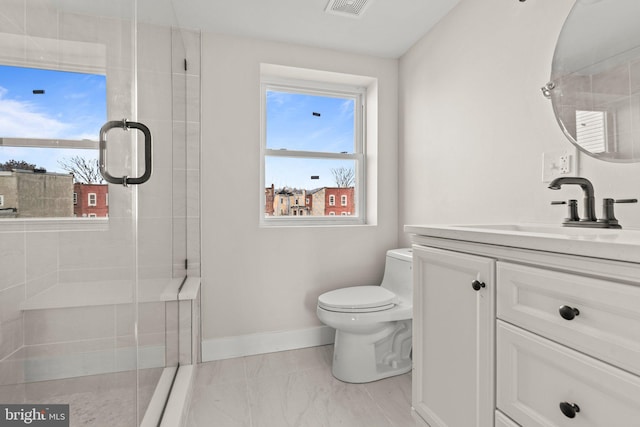 2453 Turner St, Philadelphia, PA 19121 - bathroom featuring vanity, toilet, baseboards, marble look tile flooring, and a stall shower