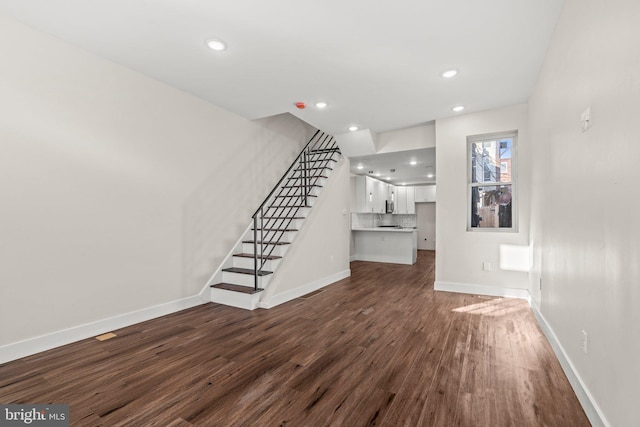 2453 Turner St, Philadelphia, PA 19121 - unfurnished living room featuring dark wood-style flooring, stairs, baseboards, and recessed lighting