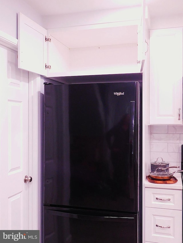 2241 Cartwright Pl, Reston, VA 20191 - kitchen view of freestanding refrigerator, white cabinets, and backsplash