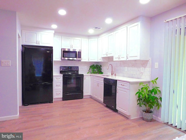 2241 Cartwright Pl, Reston, VA 20191 - kitchen with black appliances, light countertops, white cabinets, and recessed lighting