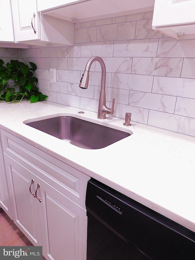 2241 Cartwright Pl, Reston, VA 20191 - kitchen featuring a sink, dishwasher, backsplash, white cabinets, and light stone counters