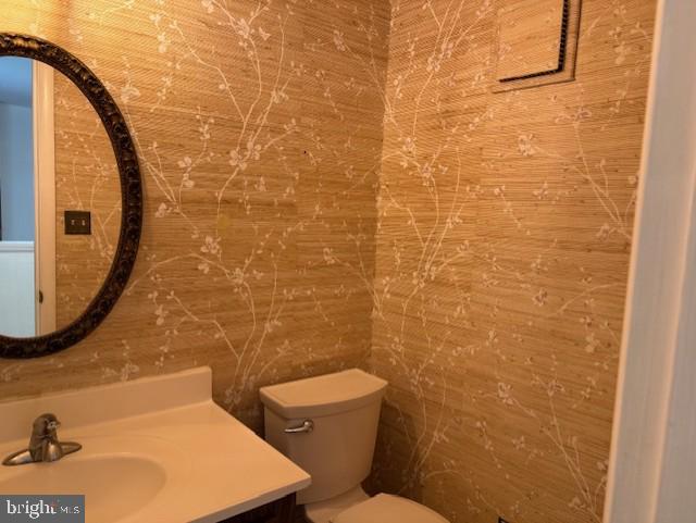 10627 Muirfield Dr, Potomac, MD 20854 - half bathroom with vanity and toilet