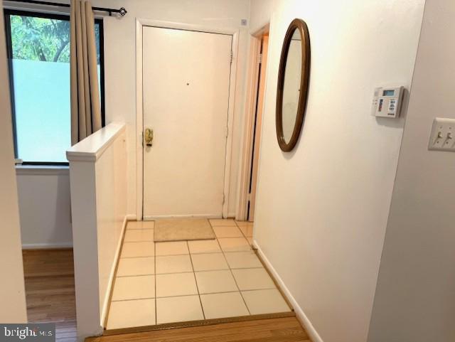 10627 Muirfield Dr, Potomac, MD 20854 - hall featuring baseboards and light tile patterned flooring