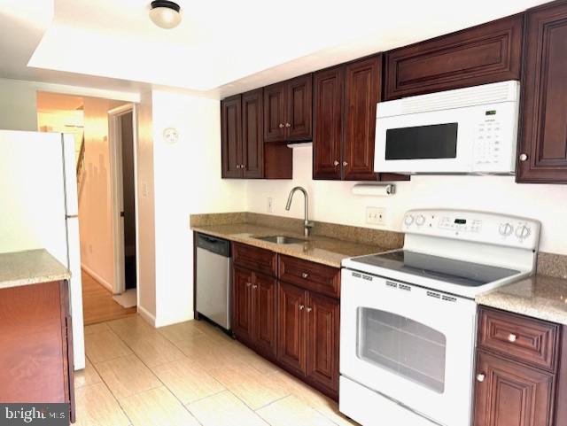 10627 Muirfield Dr, Potomac, MD 20854 - kitchen with white appliances, a sink, light countertops, and light tile patterned floors